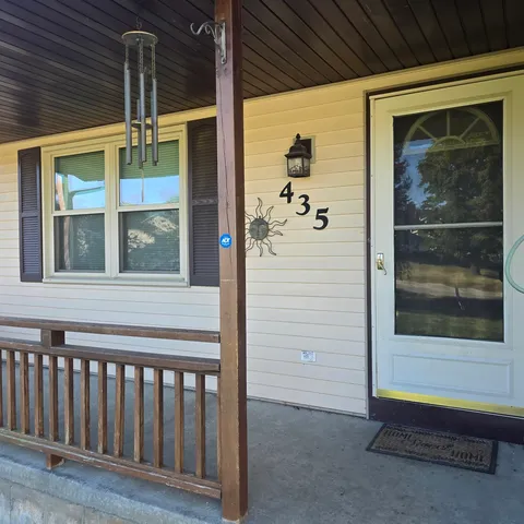 a view of a door and chair in the balcony