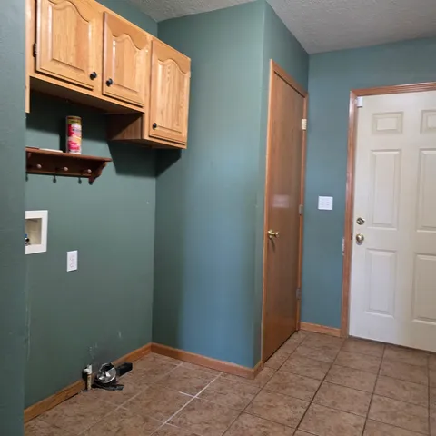a view of a livingroom with an empty space and a window