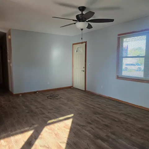 a view of an empty room and a window