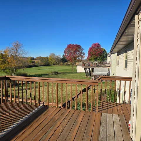 a view of balcony with wooden floor and city view