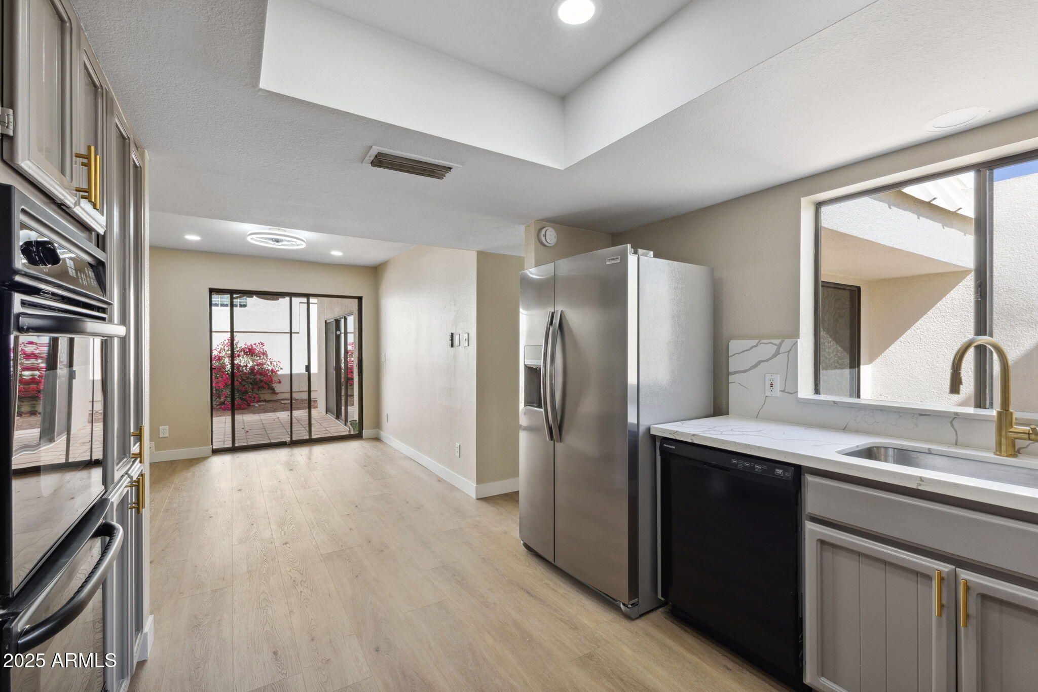 5310 North 24th Place Phoenix, AZ 85016 - Photo 12 of 35 a kitchen with stainless steel appliances granite countertop a refrigerator and a sink