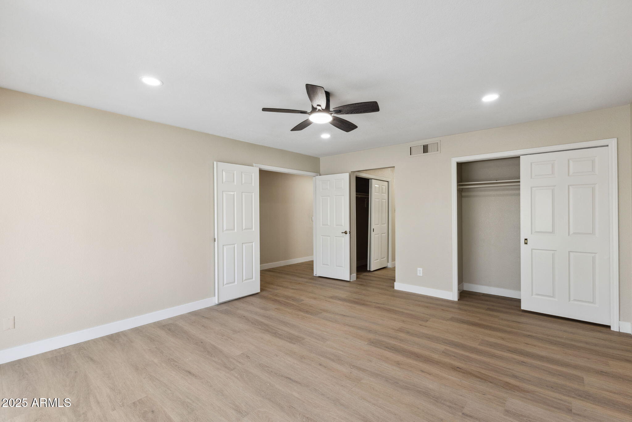 5310 North 24th Place Phoenix, AZ 85016 - Photo 16 of 35 an empty room with wooden floor and a ceiling fan