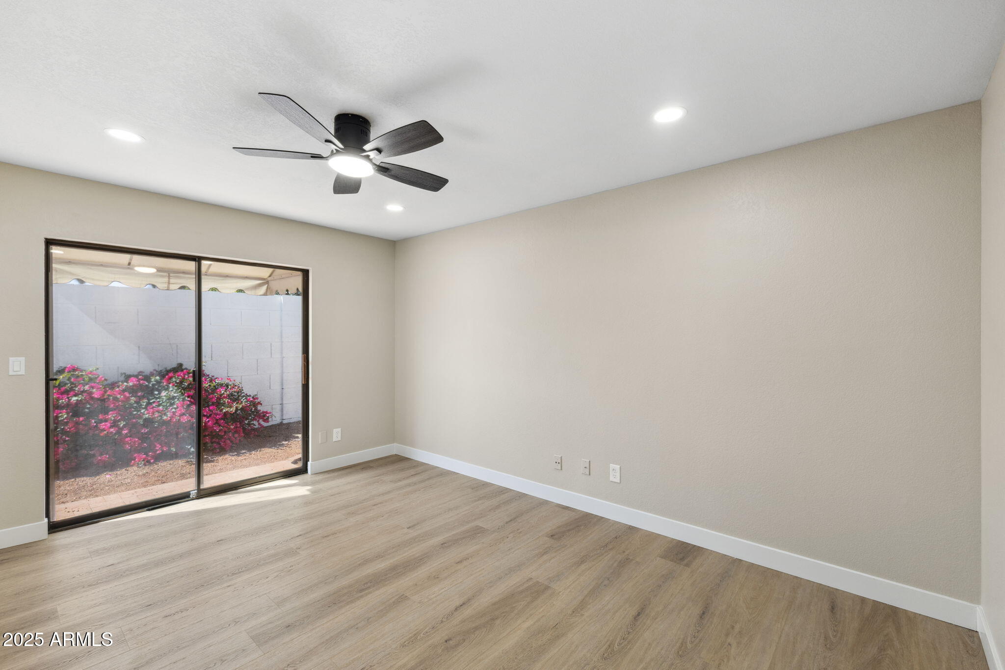 5310 North 24th Place Phoenix, AZ 85016 - Photo 20 of 35 an empty room with wooden floor and fan