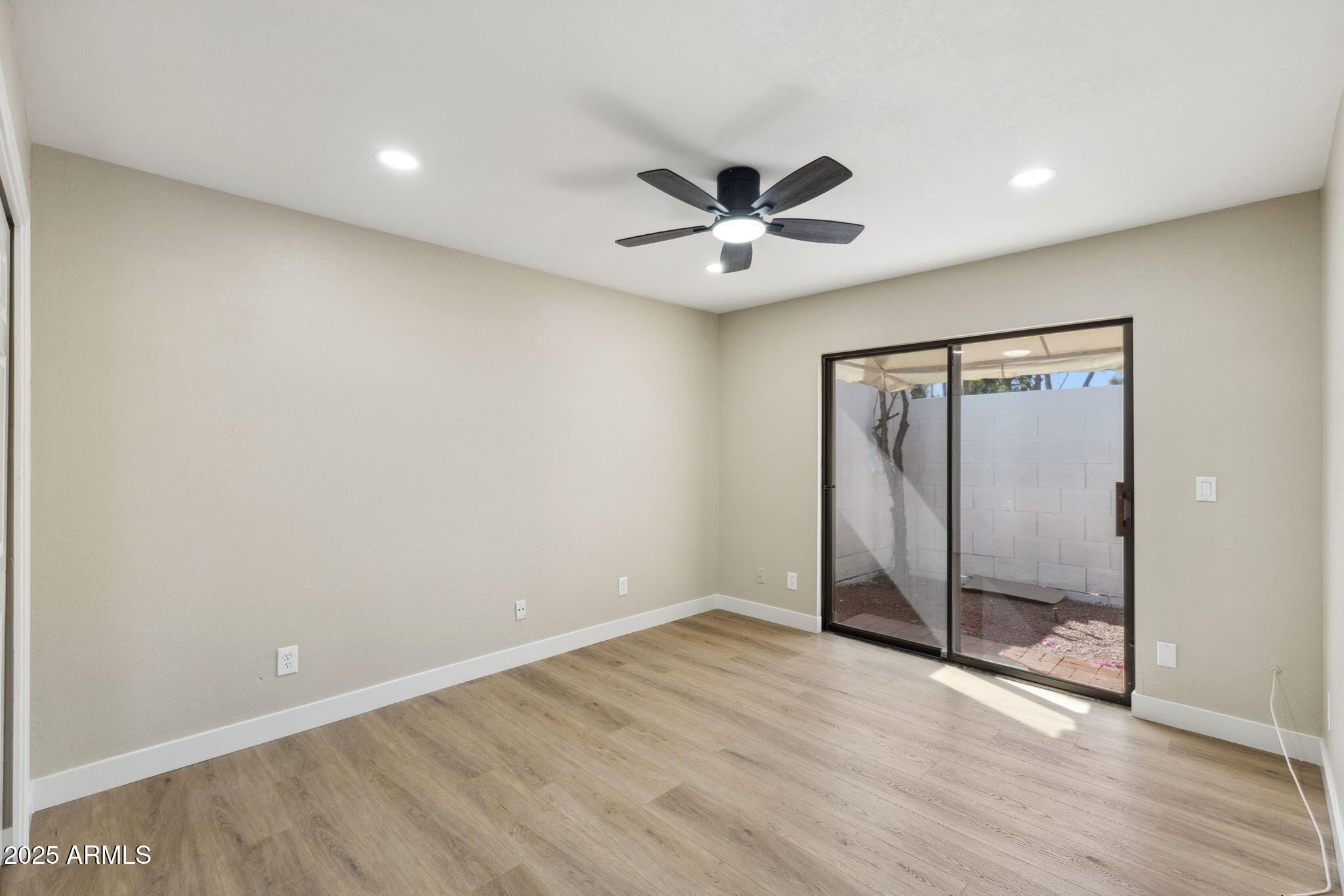 5310 North 24th Place Phoenix, AZ 85016 - Photo 21 of 35 an empty room with wooden floor and fan