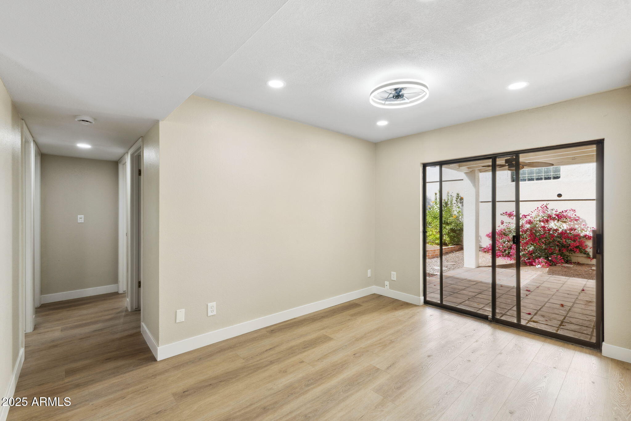 5310 North 24th Place Phoenix, AZ 85016 - Photo 22 of 35 an empty room with wooden floor and door
