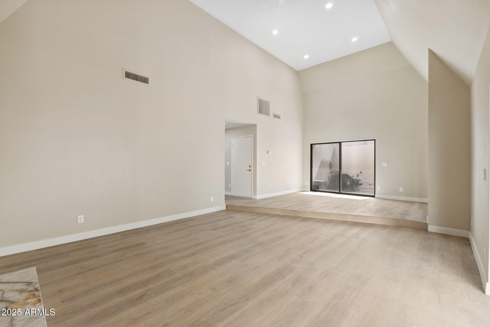 5310 North 24th Place Phoenix, AZ 85016 - Photo 6 of 35 an empty room with wooden floor and windows