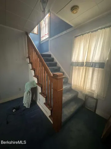 a bedroom with a bed and chair