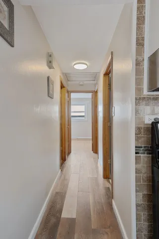 a view of a hallway with wooden shelves