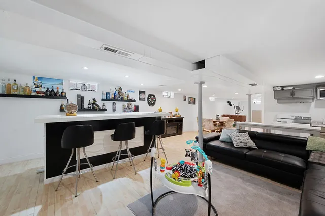 a living room with lots of furniture and kitchen view