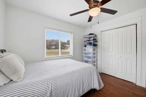 a bedroom with a bed and a large window