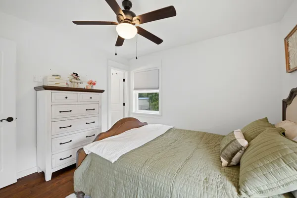 a bedroom with a bed and a window