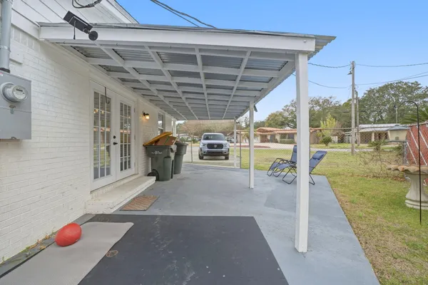 a view of a porch with wooden floor and a tub