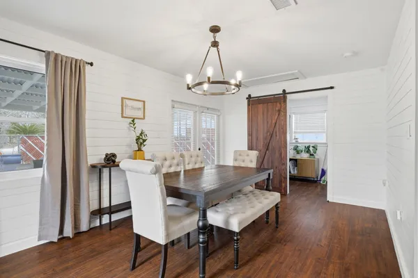 a view of a dining room with furniture window and wooden floor