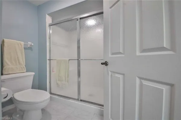 a bathroom with a toilet and a shower