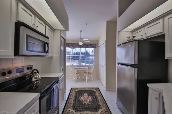a kitchen with a refrigerator and a stove