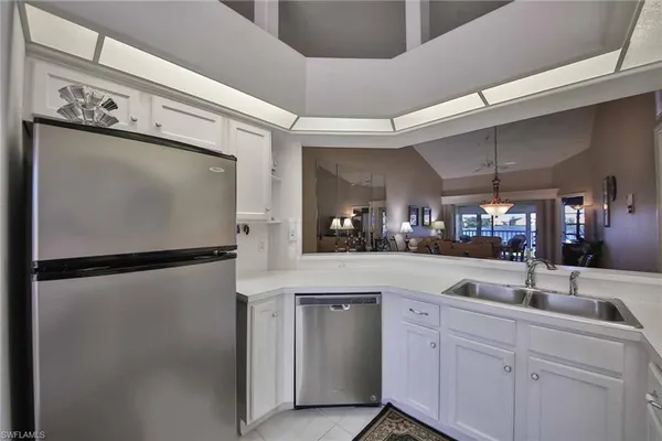 a kitchen with a refrigerator and a sink