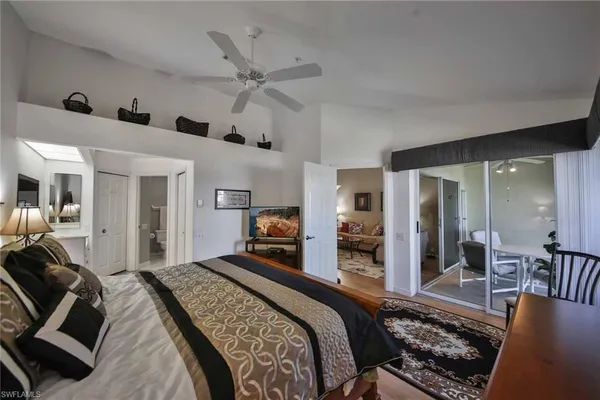 a bedroom with a large bed and a chandelier