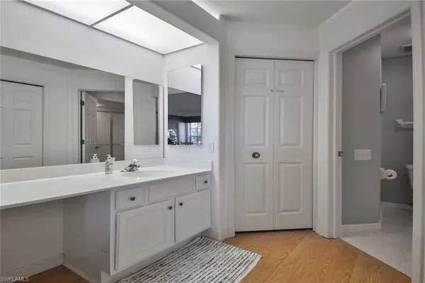 a spacious bathroom with a double vanity sink and a mirror