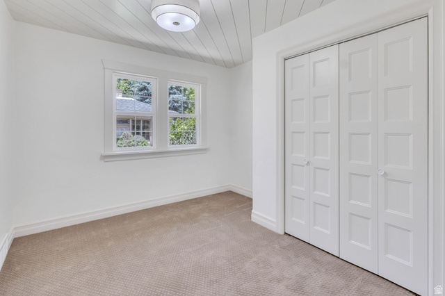 226 North 300 West Provo, UT 84601 - Photo 8 of 14 Carpeted room featuring white walls, a white shiplap ceiling, and a flush mount light fixture