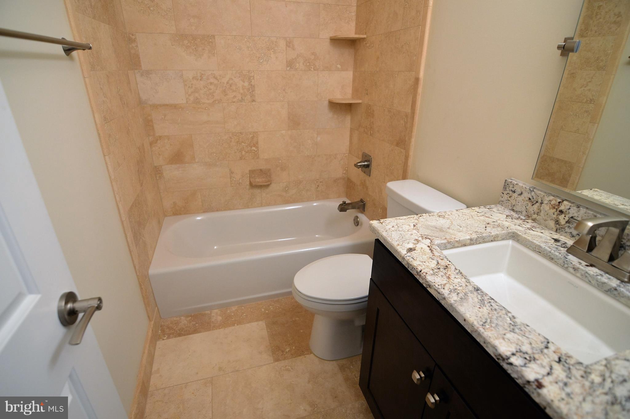 1035 Windrush Lane, Unit 9 Sandy Spring, MD 20860 - Photo 18 of 26 Hallway bathroom with granite and travertine