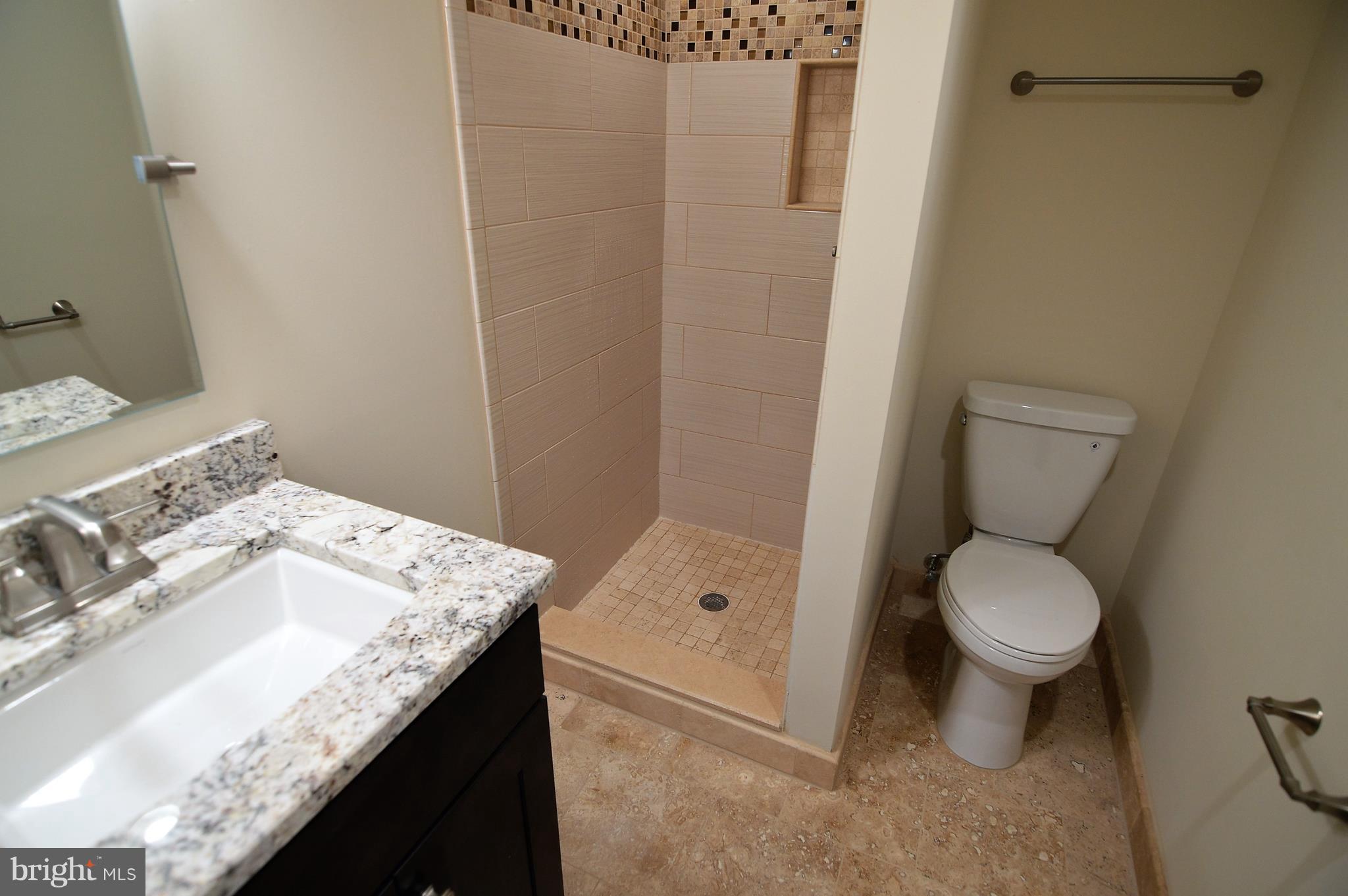 1035 Windrush Lane, Unit 9 Sandy Spring, MD 20860 - Photo 24 of 26 Basement bathroom with granite and travertine