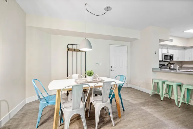 a dining room with furniture window and wooden floor