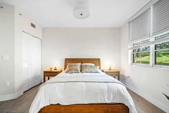a bedroom with a large bed and a large window