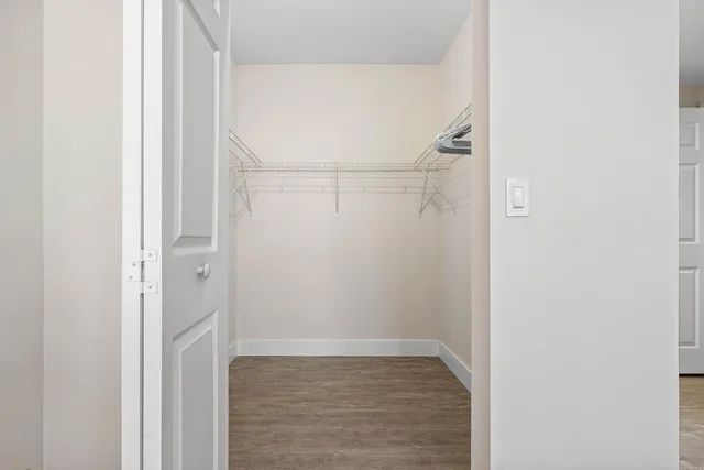 a bathroom with a granite countertop toilet sink and mirror
