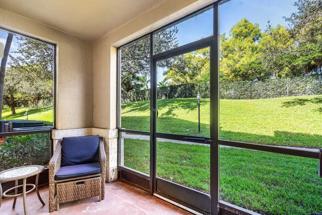 a living room with furniture and a floor to ceiling window