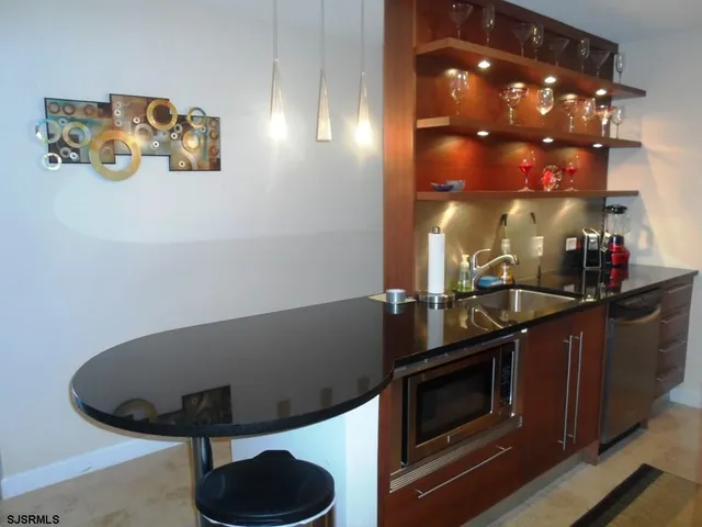 a kitchen with stainless steel appliances granite countertop a refrigerator stove and sink