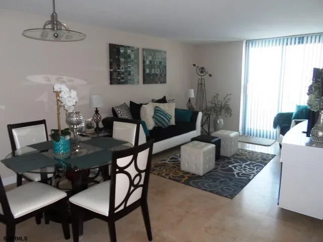 a living room with furniture rug and a window