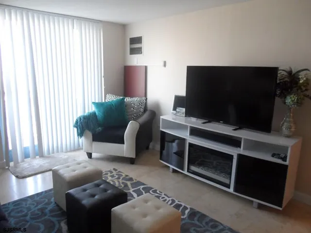 a living room with furniture a rug and a flat screen tv