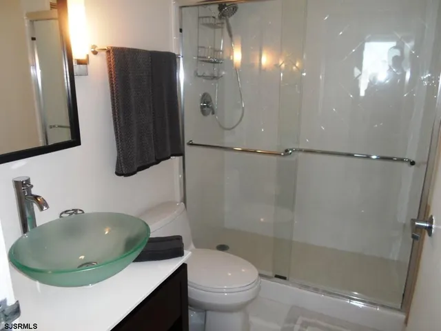 a bathroom with a shower a toilet and a sink