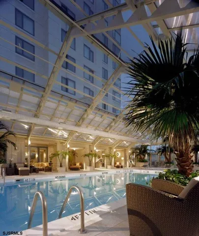 a view of a swimming pool with furniture