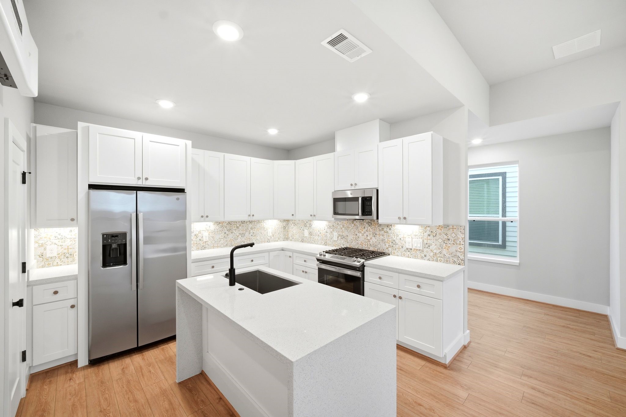 5814 Cebra Street Houston, TX 77091 - Photo 10 of 32 Gourmet kitchen with quartz countertops and elegant backsplash.
