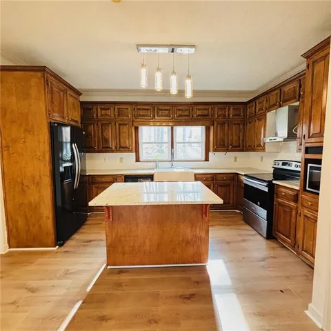 a kitchen with a sink a stove and cabinets
