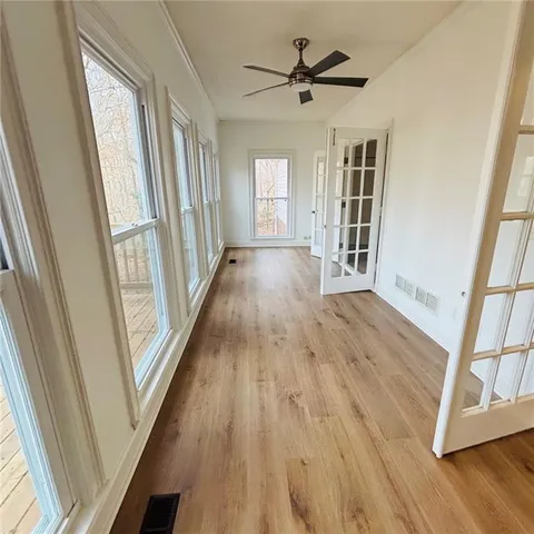 a view of balcony with wooden floor and fence