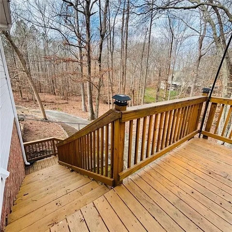 a view of wooden deck with a patio