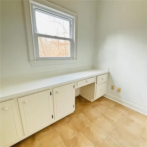 a view of room with wooden floor and ceiling fan