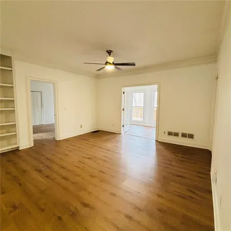 an empty room with windows and fireplace