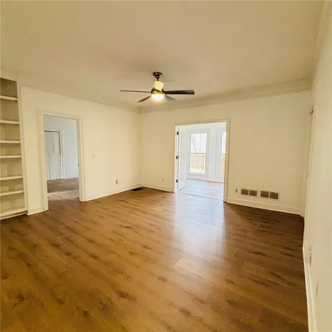 an empty room with windows and fireplace
