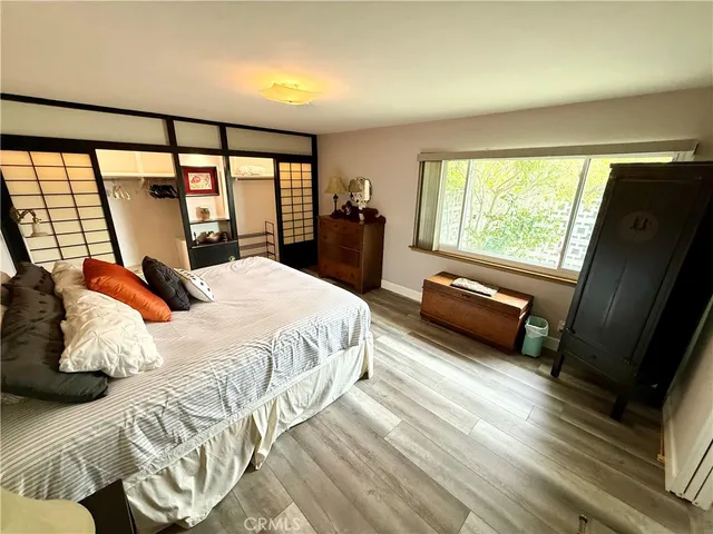 a bedroom with a bed and large window