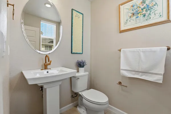 a bathroom with a toilet a sink and a mirror