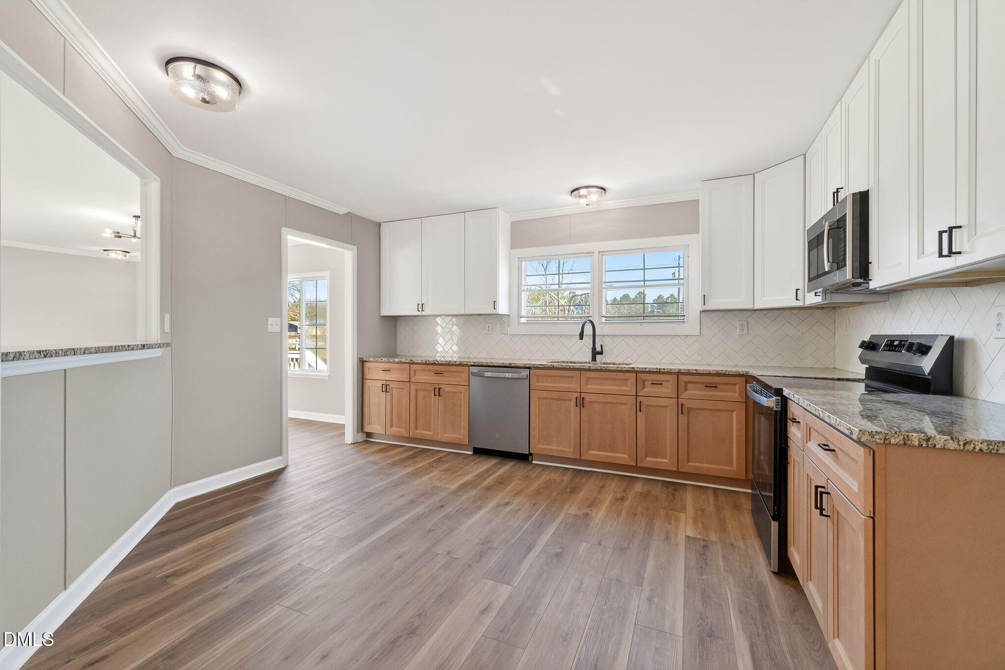 10015 Smith Road Middlesex, NC 27557 - Photo 17 of 48 a kitchen with stainless steel appliances granite countertop a sink cabinets and wooden floor