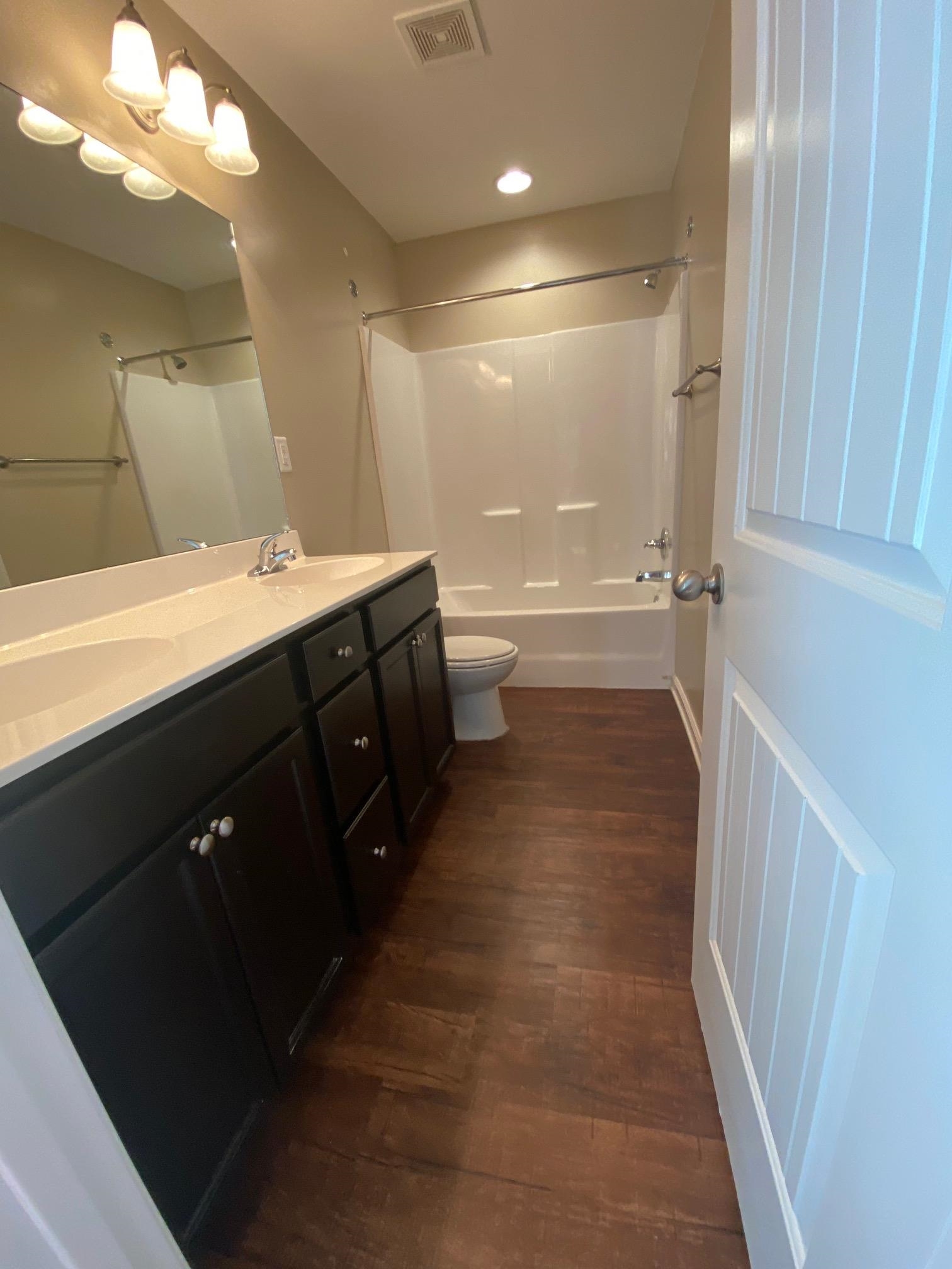 2260 Webbing Drive Memphis, TN 38016 - Photo 5 of 17 a bathroom with a sink a toilet and a large mirror