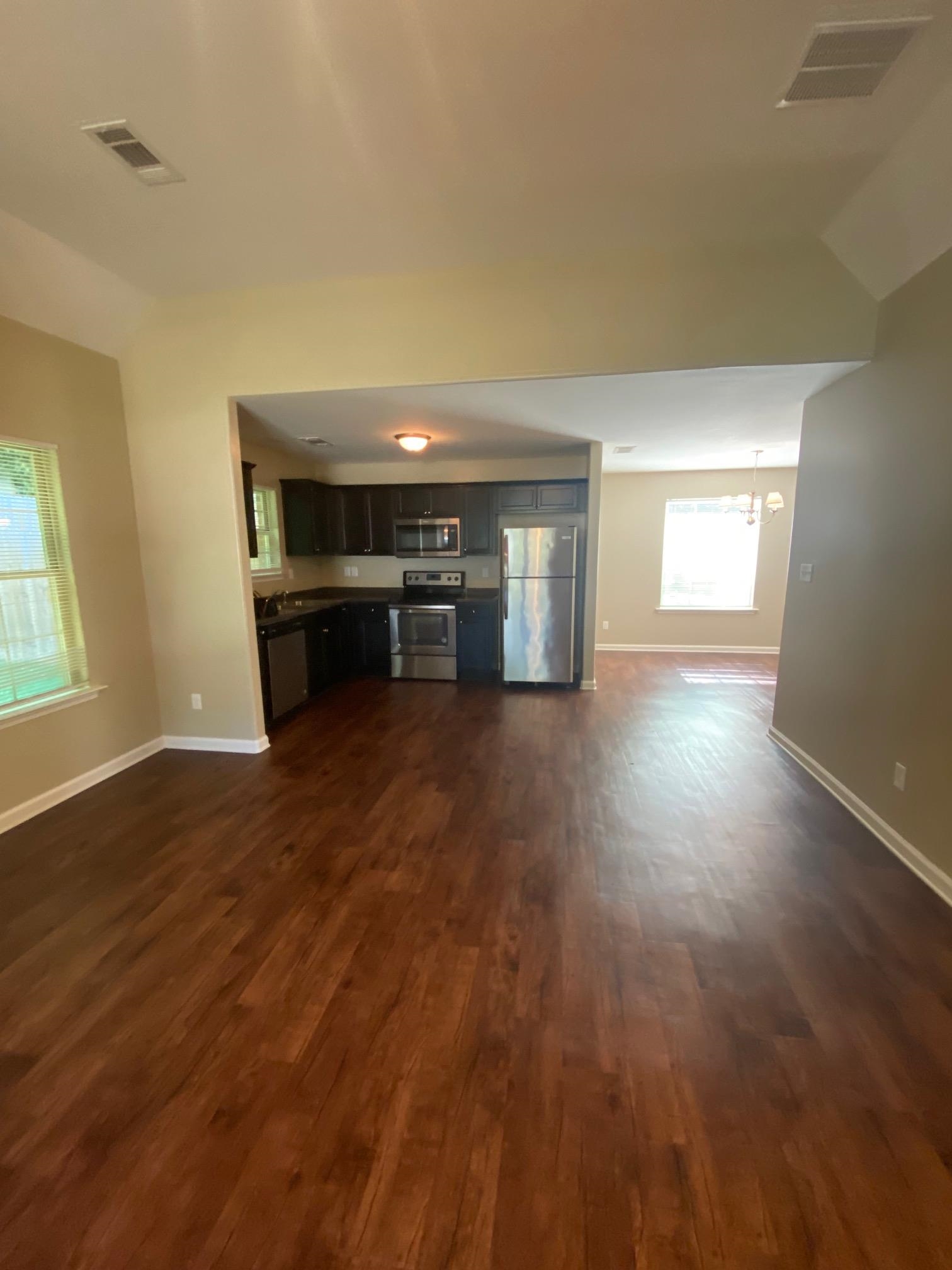 2260 Webbing Drive Memphis, TN 38016 - Photo 9 of 17 an empty room with wooden floor and windows