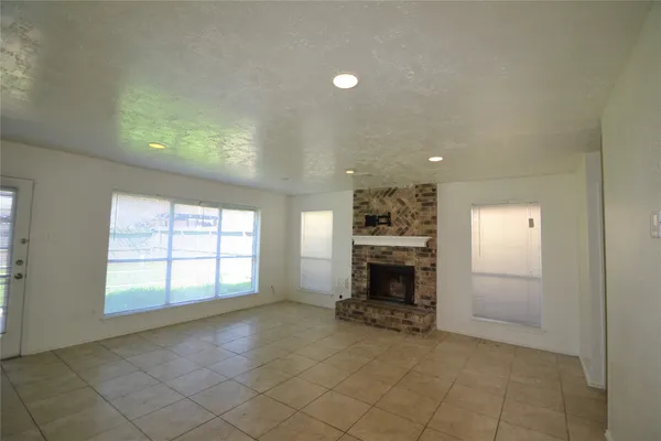 an entryway and an empty room with a window