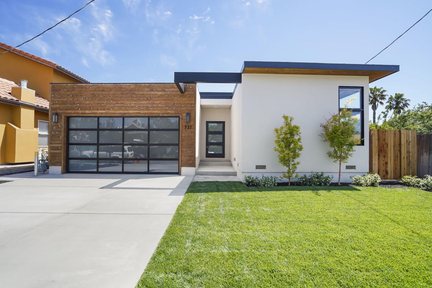 737 Ruby Street Redwood City, CA 94061 - Photo 1 of 26 a front view of a house with a yard and garage