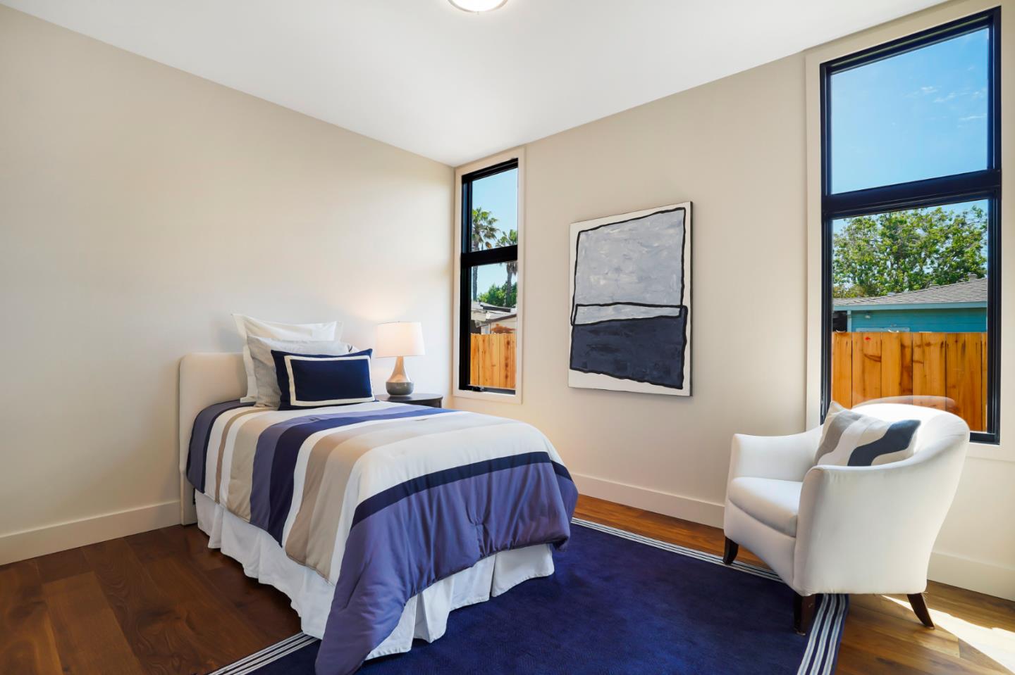 737 Ruby Street Redwood City, CA 94061 - Photo 13 of 26 a bedroom with a bed and wooden floor