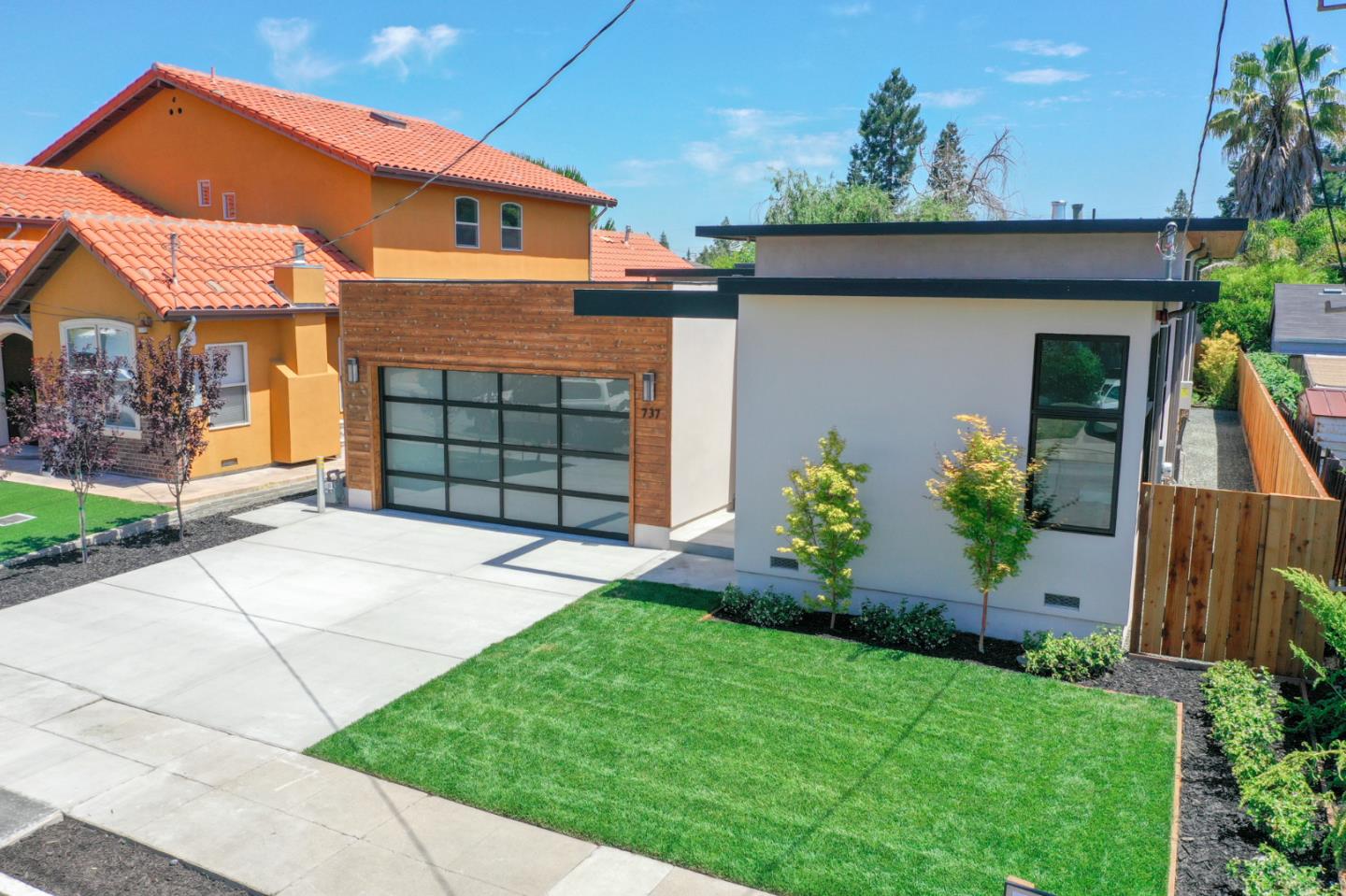 737 Ruby Street Redwood City, CA 94061 - Photo 22 of 26 a front view of a house with a garden and plants